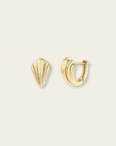 a pair of gold earrings on a white background