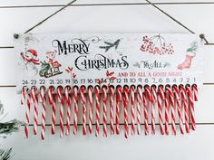 a christmas sign hanging from the side of a wall