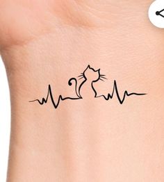 a cat and heartbeat tattoo on the back of a woman's left side arm