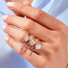 a woman's hand with three rings on it