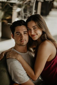 a young man and woman embracing each other