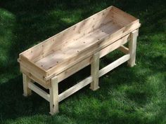 a wooden bench sitting in the grass