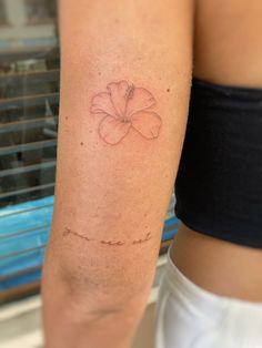 a woman's arm with a flower tattoo on the left side of her body