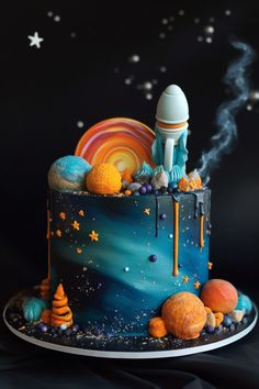 a cake decorated with an image of a space shuttle on top of it, surrounded by planets and stars