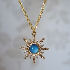 Make a statement with this pretty blue sun drop necklace for women. This cool quirky gold plated and acrylic blue sun necklace is a great way to add a nice touch to your outfit. The charm on this ladies sun necklace measures at 3cm x 2.7cm and is attached to a gold plated chain with lobster clasp. Various lengths of necklace chain are available, please select a length from the drop down menu. Please feel free to get in touch with us at Funky Earrings UK if you have any questions. We also have a wide range of other cute and unusual earrings and necklaces for her in our shop. Cheap Fun Blue Necklaces, Cheap Blue Necklaces With Star Charm, Cheap Blue Necklaces, Cheap Cute Blue Necklaces, Cheap Blue Hippie Jewelry, Trendy Cheap Blue Necklace, Cheap Trendy Blue Jewelry, Cheap Hippie Blue Jewelry, Cheap Themed Blue Jewelry