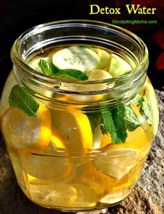 a jar filled with lemon slices and cucumbers