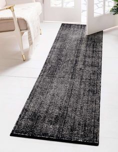 a black and white runner rug in a living room