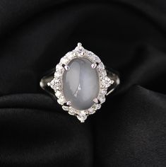 Presenting you Beautiful Vintage Style White Moonstone Ring as done in the Previous Era with Bigger Size Cabochon with side accents to give you exact vintage feels with a split shank styling. Perfect Gift for Bride Wedding or Anniversary or can be a proposal or promise Ring too. Wear it to make the Difference. Item No: skj.27.494 Item: White Moonstone Ring in 925 Sterling Silver Primary Stone: Natural White Moonstone Secondary Stone: Cubic Zircon Article Weight:6.2 gms primary stone Size: 14x10 mm Ring Length:2.1 cm Ring Width:2.1 cm Maintenance Tips 1. Keep the jewelry away from direct heat, water, perfumes, deodorants, and other strong chemicals.  2. Wipe the Jewellery gently with a chamois cloth or leather swatch after every use.  3. Wiping the jewelry with a soft cloth after removing t Oval Diamond White Crystal Ring With Gemstone, Elegant White Crystal Ring With Gemstone Accents, Elegant Moonstone Crystal Ring With Cabochon, Elegant Moonstone Rings With Gemstone Accents, Elegant Cabochon Moonstone Crystal Ring, Elegant Moonstone Cabochon Crystal Ring, Silver Oval Diamond Moonstone Ring, Elegant Silver Oval Moonstone Ring, Oval Silver Moonstone Ring With Diamond