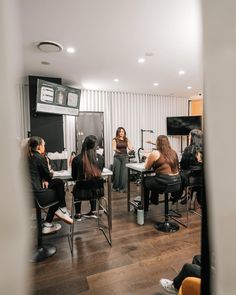 a group of women sitting at desks in a room