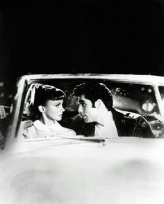 two people in a car looking at each other