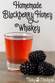 homemade blackberry honey whiskey in a glass next to blackberries