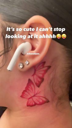 a woman with a red butterfly tattoo on her ear and behind the ear is an ear piercing