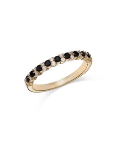 a yellow gold ring with black and white diamonds