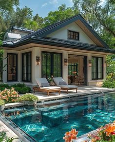 a house with a pool in front of it and some flowers around the pool area