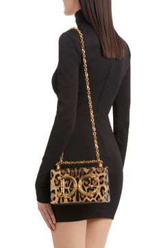 A baroque-inspired D&G logo adds to the glamour of this leopard-print leather bag featuring a pull-through strap that allows for crossbody or shoulder wear. Magnetic-snap flap closure Pull-through chain strap Leather lining Leather Made in Italy Designer Handbags Elegant Leopard Print Party Bag, Elegant Evening Shoulder Bag In Leopard Print, Evening Leopard Print Shoulder Bag With Detachable Strap, Leopard Print Shoulder Bag With Detachable Strap For Evening, Evening Shoulder Bag In Leopard Print With Detachable Strap, Luxury Leopard Print Bags For Formal Events, Elegant Leopard Print Shoulder Bag With Detachable Handle, Leopard Print Shoulder Bag With Gold-tone Hardware, Elegant Leopard Print Bag With Detachable Strap