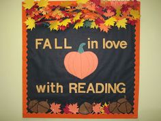 fall in love with reading bulletin board hanging on the wall next to a pile of leaves