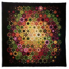 a black square with colorful flowers in the center and green, yellow, red, orange, pink, purple