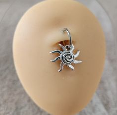 a ring with a sun on it sitting on top of a dummy's head