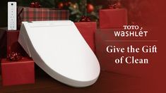 a toilet with christmas presents around it and the words toto washlet give the gift of clean