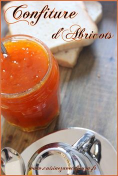 an orange juice in a jar next to some toast on a plate with the words confiture d'apricots