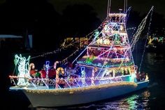 a boat decorated with christmas lights on the water