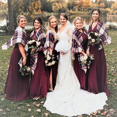 a bride and her bridals posing in front of a pond