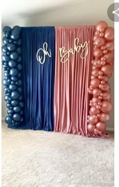 some balloons are in the shape of letters and numbers on top of blue, pink, and purple drapes