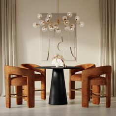 a dining room table with four chairs and a chandelier hanging from the ceiling