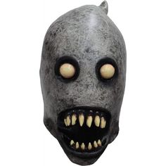 a creepy mask with teeth and fangs on it's face is shown in front of a white background