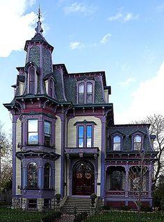 an old victorian style house with purple trim