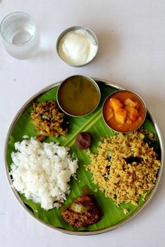 a plate with rice, meat and sauces on it