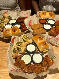 three baskets filled with different types of food sitting on top of a wooden table next to each other