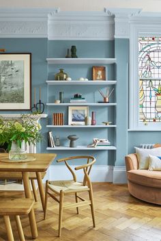 a living room filled with furniture and stained glass windows