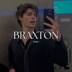 a man taking a selfie in front of a mirror with the words braxton on it