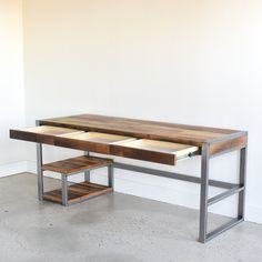 a wooden desk with two drawers underneath it