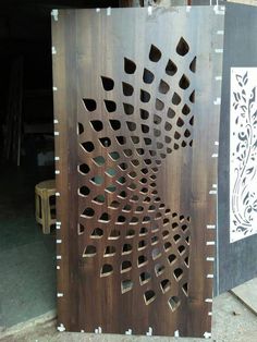 a wooden door with holes in the middle and an intricate design on it's side