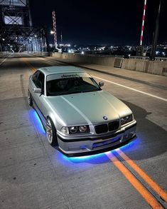 a silver car with blue lights on it