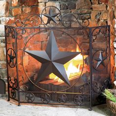 a fire place with a metal star on the top and an iron frame around it