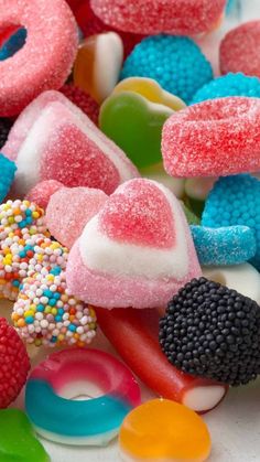 colorful candy candies are scattered on a white surface