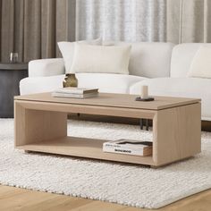 a coffee table sitting on top of a white rug