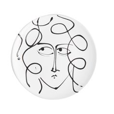 a white plate with a black and white drawing of a woman's face on it