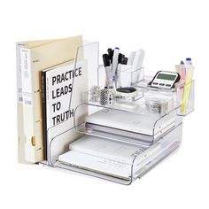 an organized desk organizer with office supplies on the bottom shelf and in front of it's contents