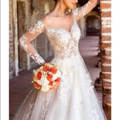 a woman in a wedding dress is posing with her hand on her head and holding a bouquet