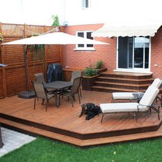 a deck with chairs and an umbrella on it