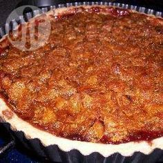 a pie sitting on top of a stove covered in toppings