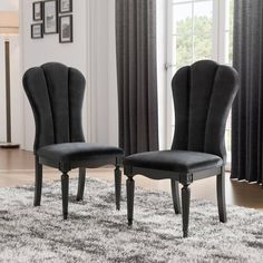 two black chairs sitting on top of a rug