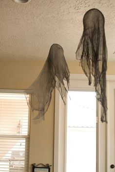 two halloween decorations hanging from the ceiling