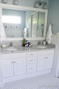 a bathroom with two sinks and a large mirror