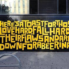 a large yellow and black sign on the side of a building