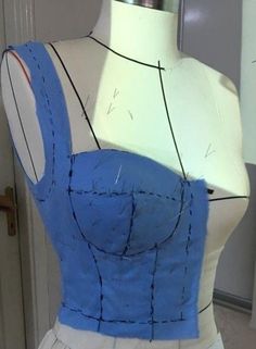 a mannequin wearing a blue and white dress with black lines on it's chest